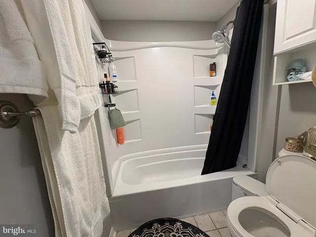 a bathroom with a bathtub a sink and toilet