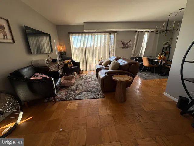 a living room with furniture a large window and gym equipment