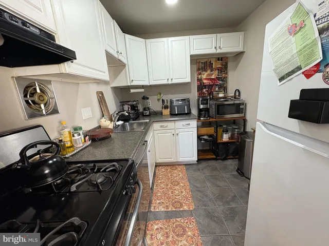 a kitchen with a stove and a refrigerator