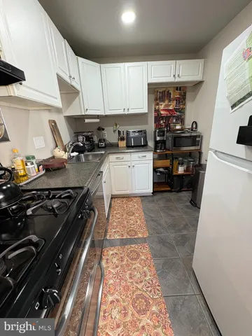 a kitchen with a stove a sink and a refrigerator