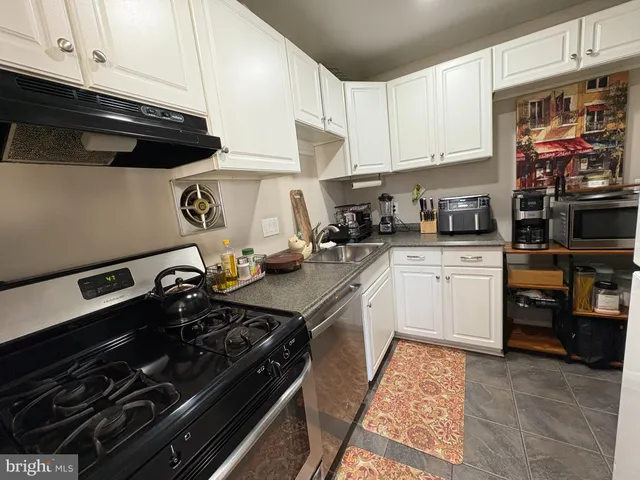 a kitchen with a stove and a refrigerator