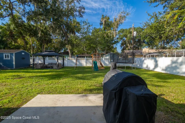 a view of a garden with a house in the background