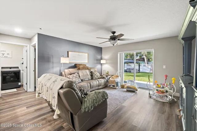 a living room with furniture fireplace and a table
