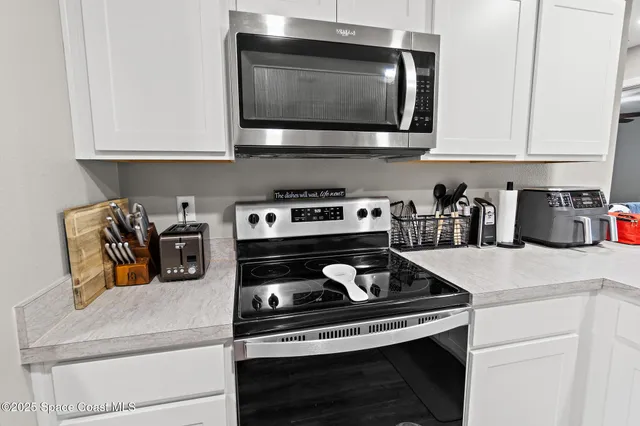 a kitchen with a stove and a microwave
