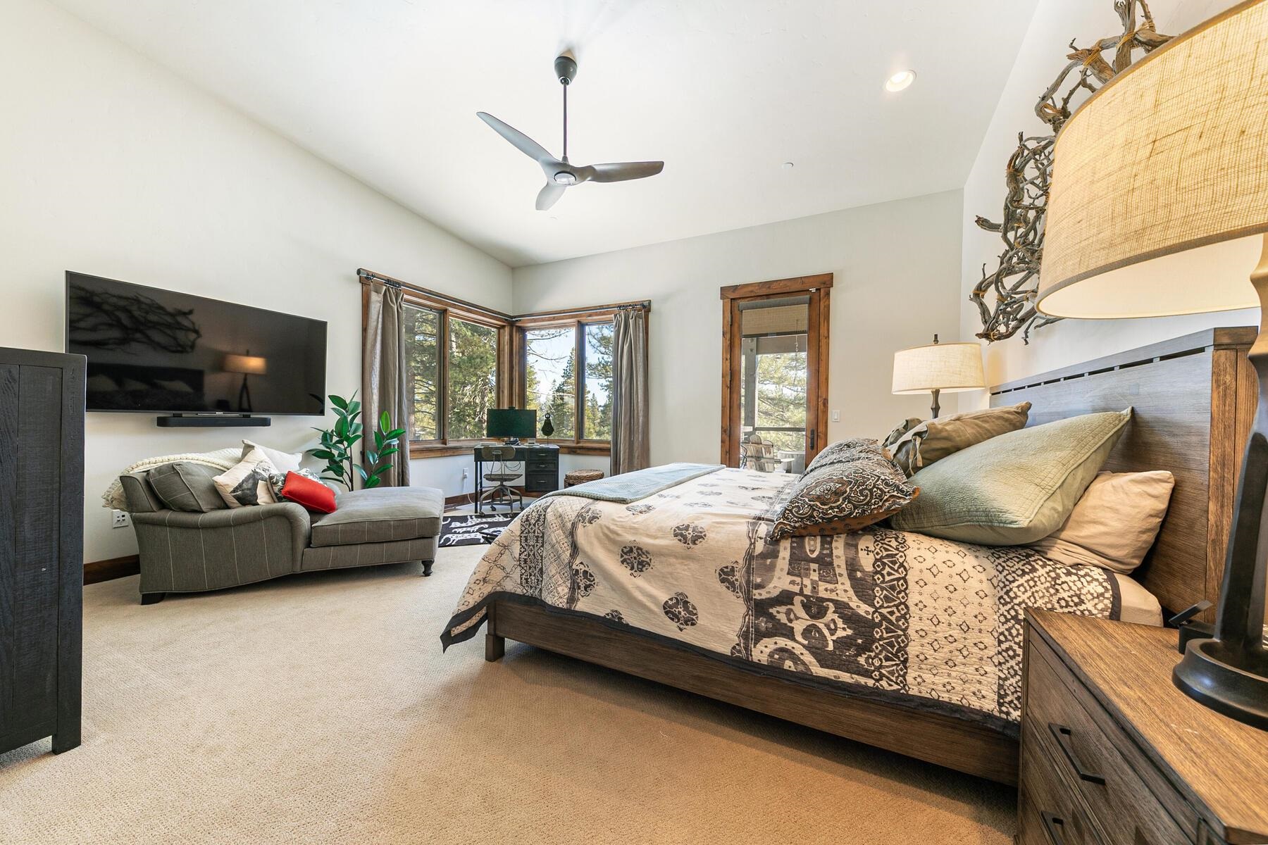 a bedroom with furniture and a flat screen tv