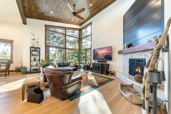 a living room with furniture a fireplace and a flat screen tv