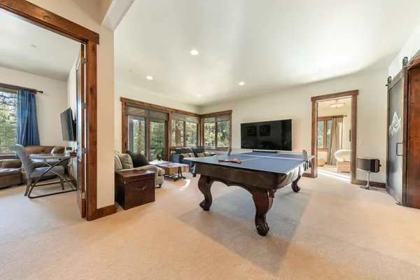 a living room with furniture a flat screen tv and a table