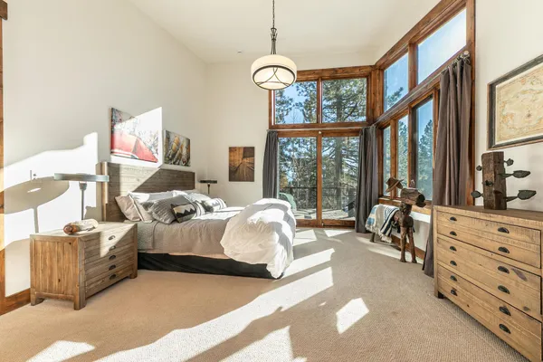 a bed room with bed and a large window