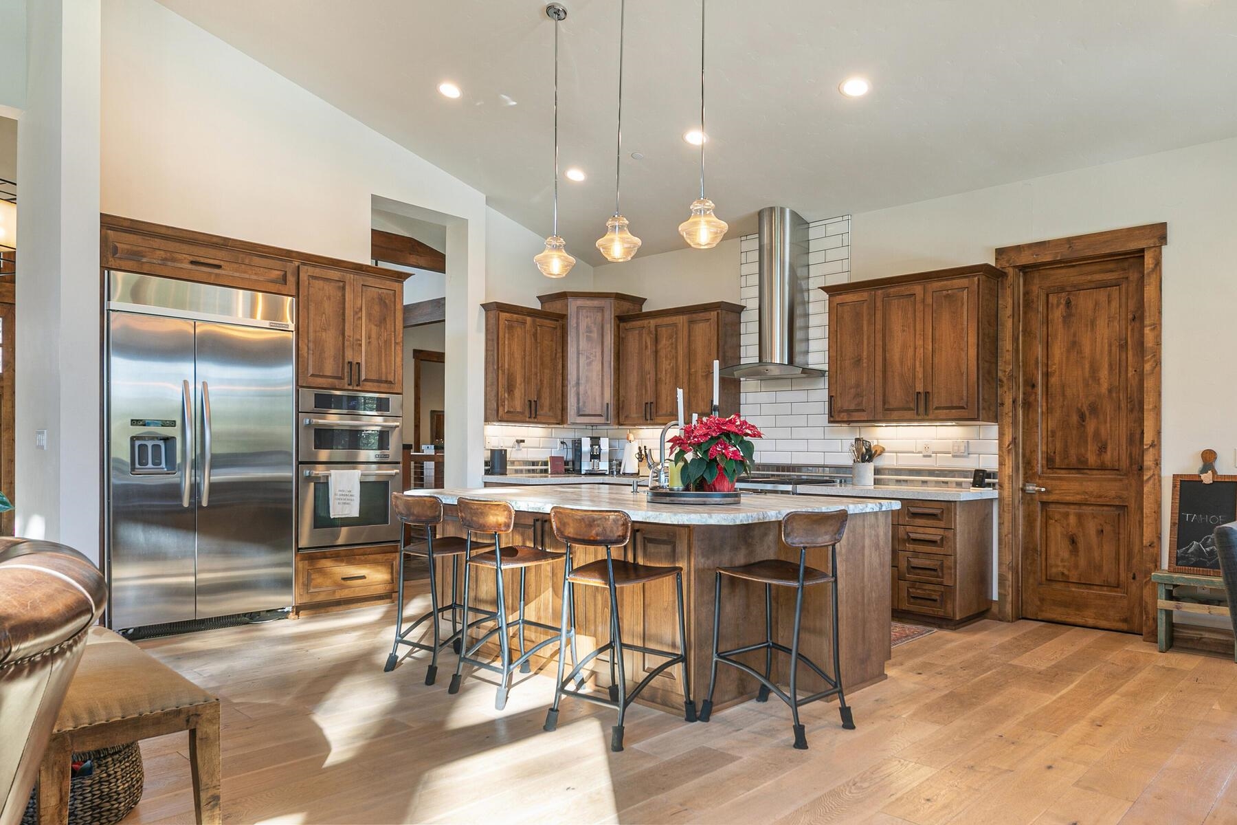10789 Labelle Court Truckee, CA 96161 - Photo 8 of 28 a kitchen with stainless steel appliances kitchen island granite countertop a dining table chairs sink and cabinets
