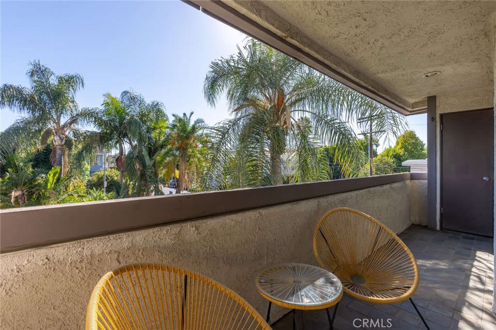 20253 Keswick Street Winnetka, CA 91306 - Photo 16 of 22 a view of a balcony with chair and table