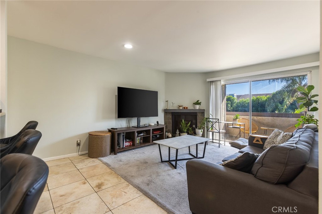 20253 Keswick Street Winnetka, CA 91306 - Photo 3 of 22 a living room with furniture and a flat screen tv