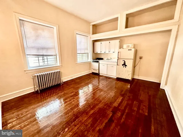 a view of a room with wooden floor and a window