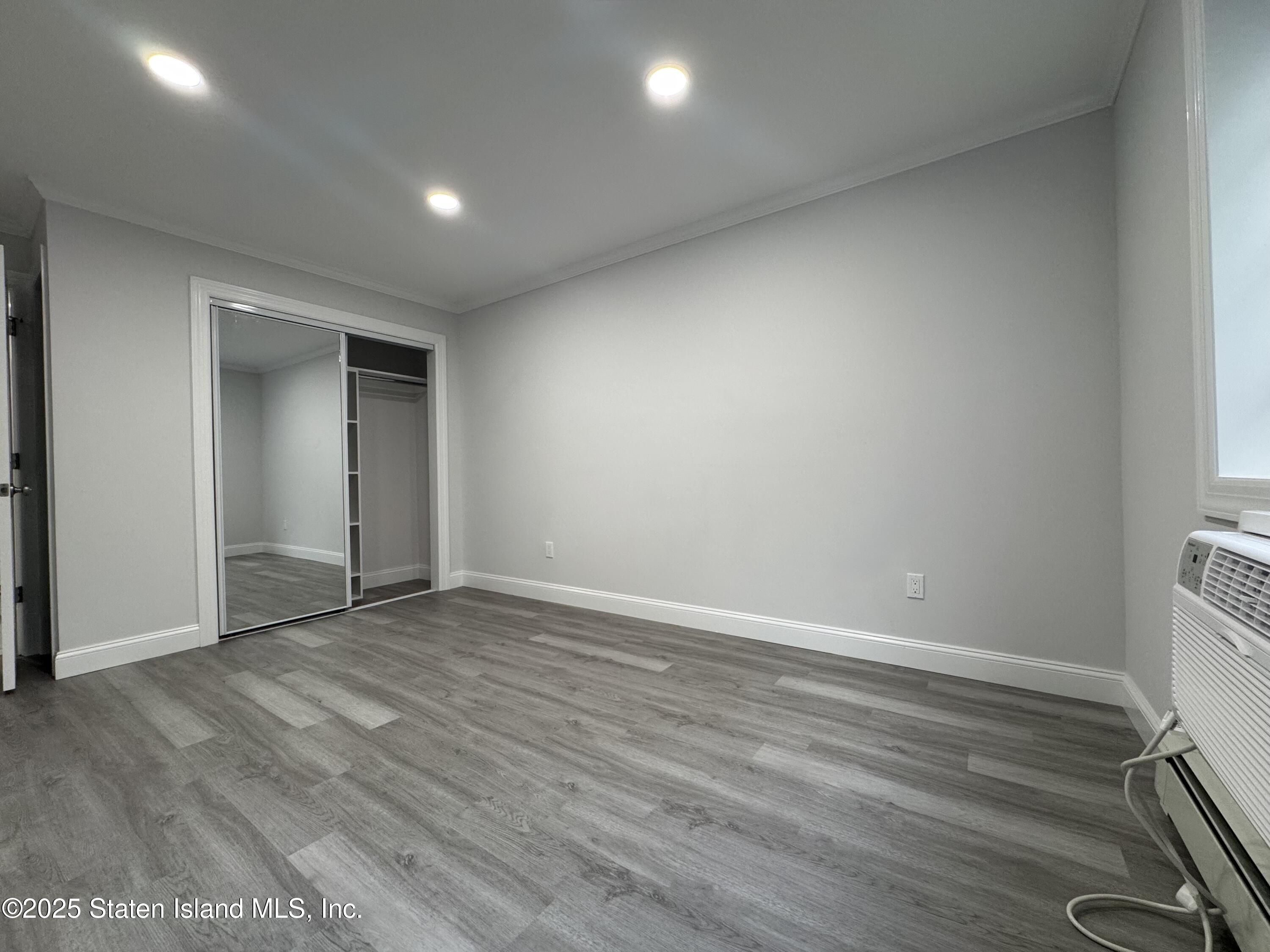 170 Devon Loop, Unit 2 Staten Island, NY 10314 - Photo 4 of 9 wooden floor in an empty room