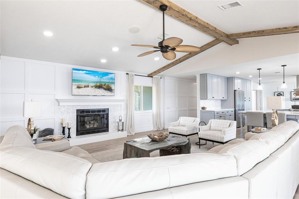 8115 Manasota Key Road Englewood, FL 34223 - Photo 23 of 67 a living room with furniture a fireplace and a ceiling fan