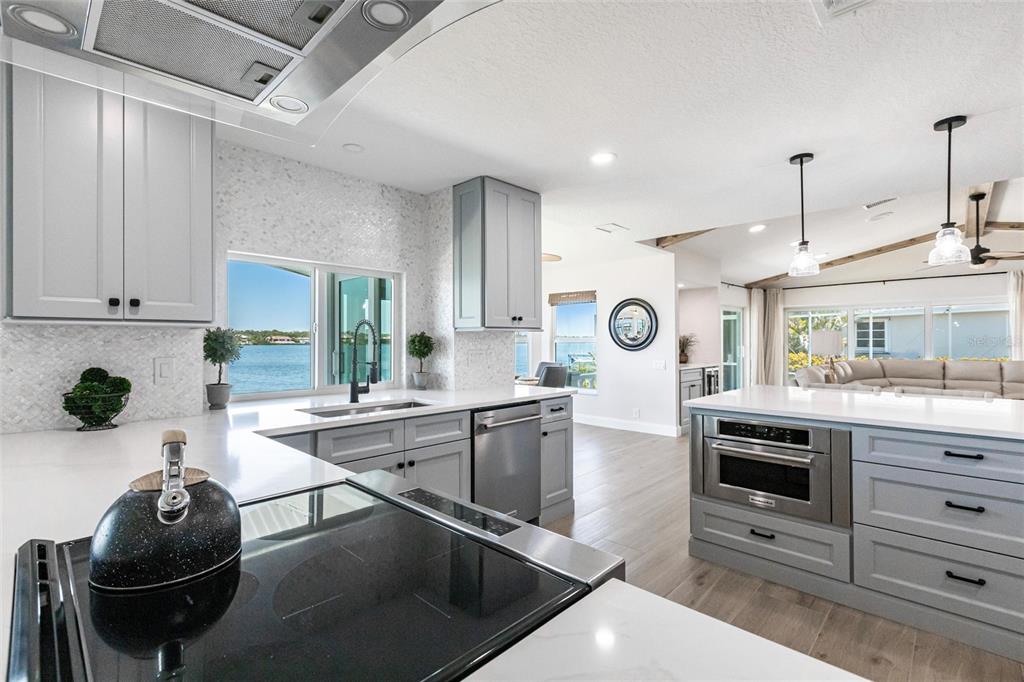 8115 Manasota Key Road Englewood, FL 34223 - Photo 29 of 67 a kitchen with stainless steel appliances kitchen island granite countertop a stove and a sink
