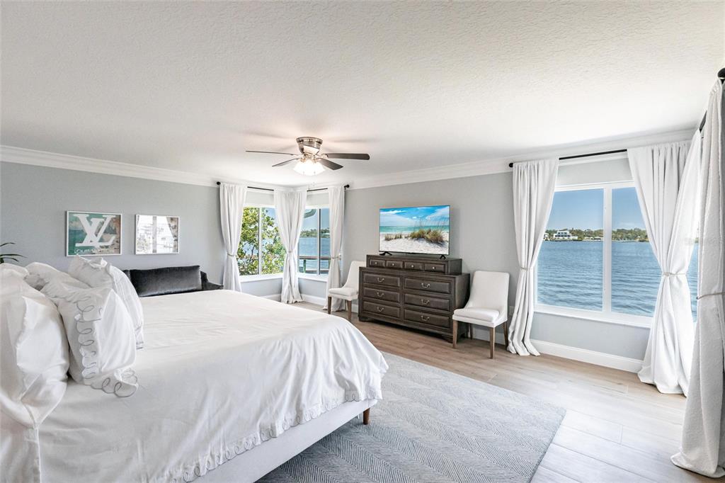 8115 Manasota Key Road Englewood, FL 34223 - Photo 36 of 67 a bedroom with a bed and a chandelier