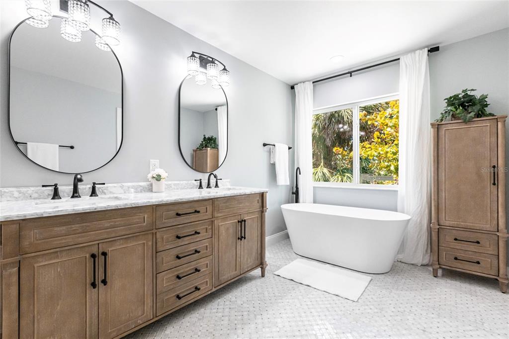 8115 Manasota Key Road Englewood, FL 34223 - Photo 42 of 67 a bathroom with a double vanity sink and a mirror