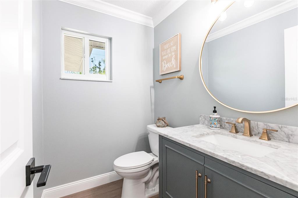8115 Manasota Key Road Englewood, FL 34223 - Photo 52 of 67 a bathroom with a granite countertop sink mirror and toilet