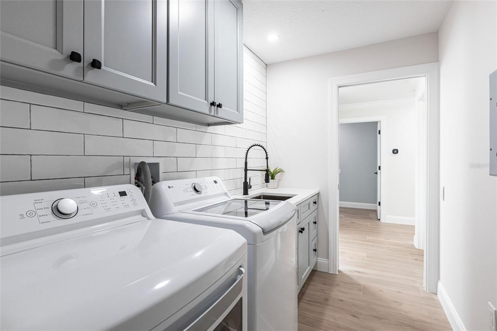 8115 Manasota Key Road Englewood, FL 34223 - Photo 59 of 67 a utility room with sink dryer and washer