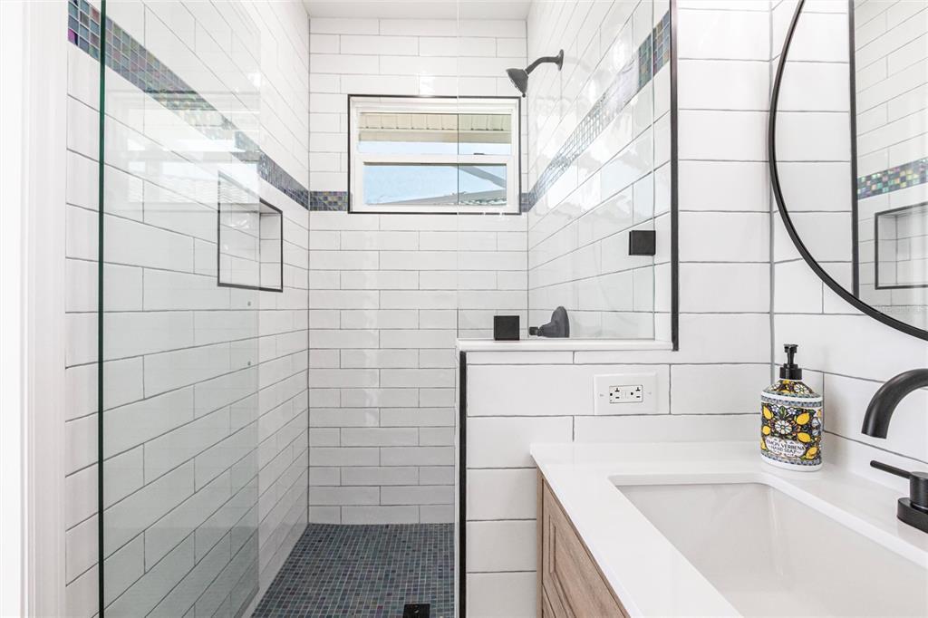 8115 Manasota Key Road Englewood, FL 34223 - Photo 62 of 67 a bathroom with a sink and a shower