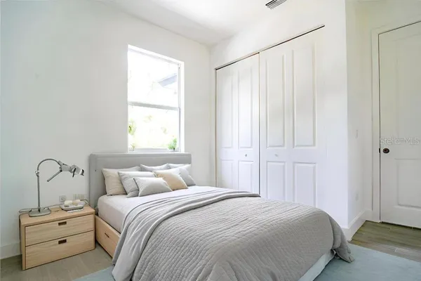 a bedroom with a bed and a window