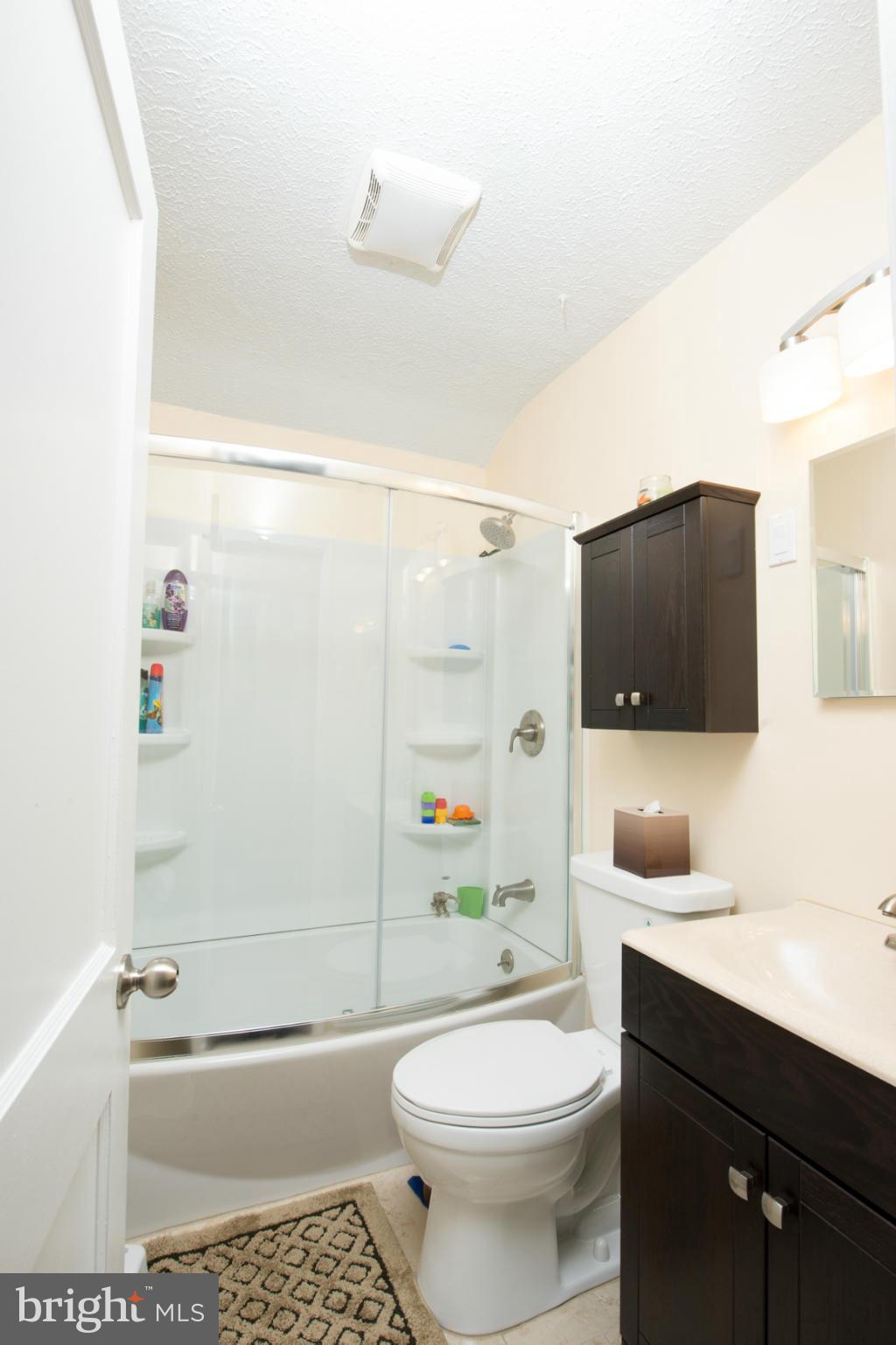 8331 Kavanagh Road Baltimore, MD 21222 - Photo 19 of 28 a bathroom with a bathtub shower sink vanity and toilet
