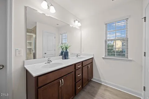 a bathroom with a sink double vanity and a mirror