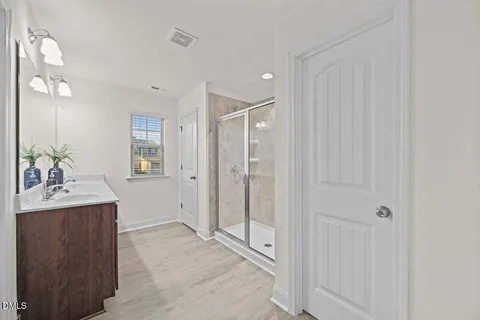 a bathroom with a shower sink and mirror