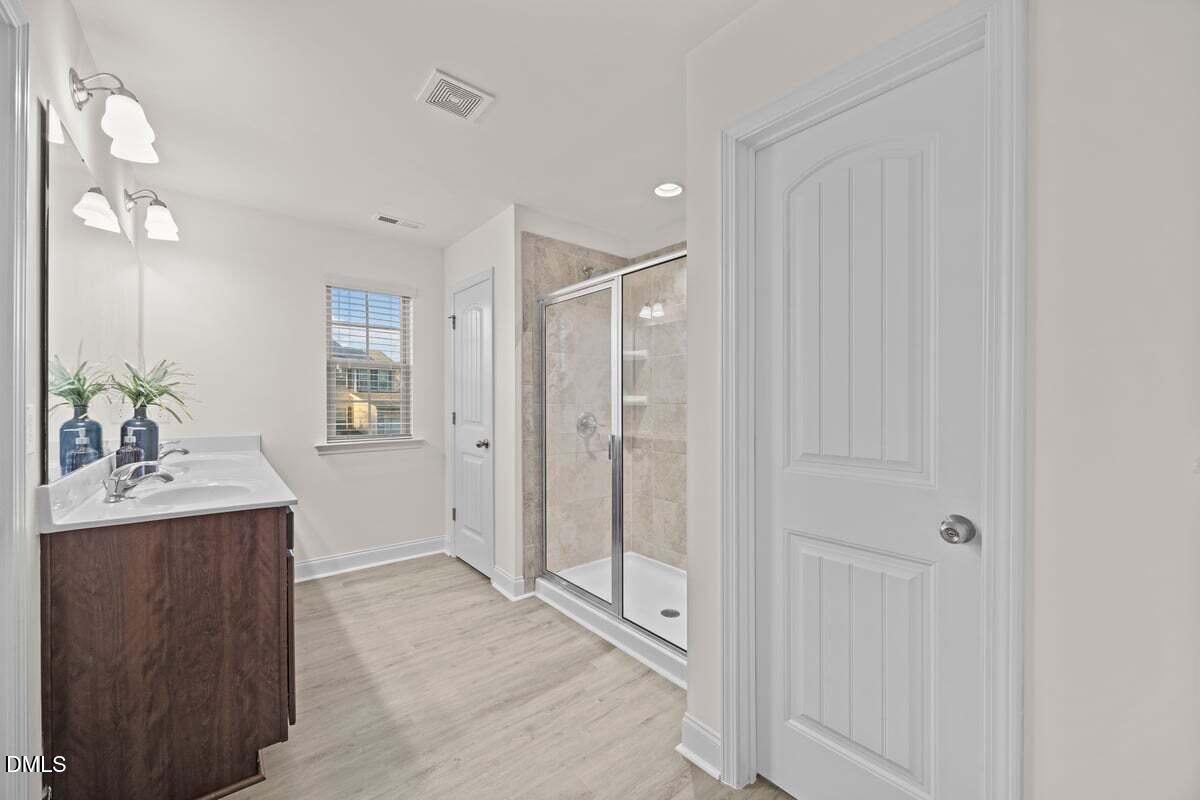 917 Stable Fern Drive Fuquay-Varina, NC 27526 - Photo 19 of 31 a bathroom with a shower sink and mirror