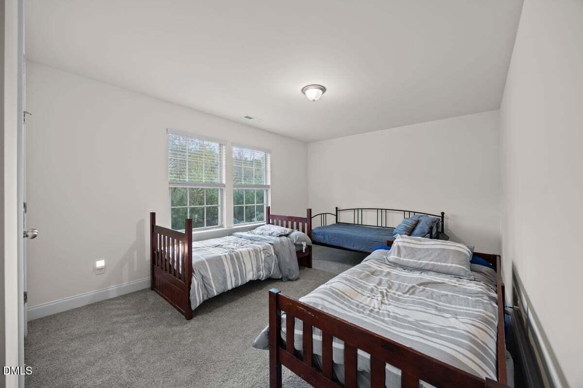 917 Stable Fern Drive Fuquay-Varina, NC 27526 - Photo 20 of 31 a bedroom with two beds and a large window