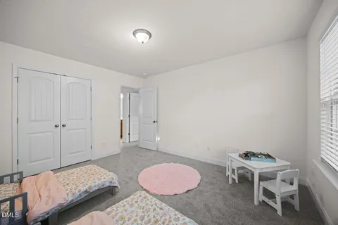 a bedroom with a bed and a chair