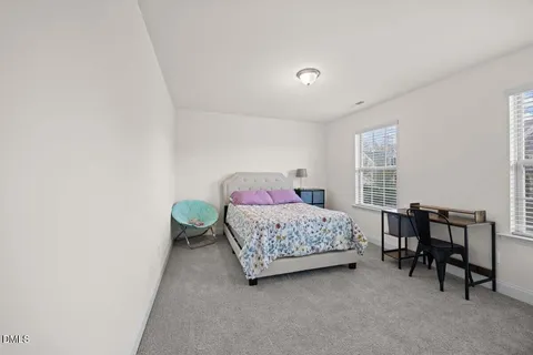 a bedroom with a bed and a table