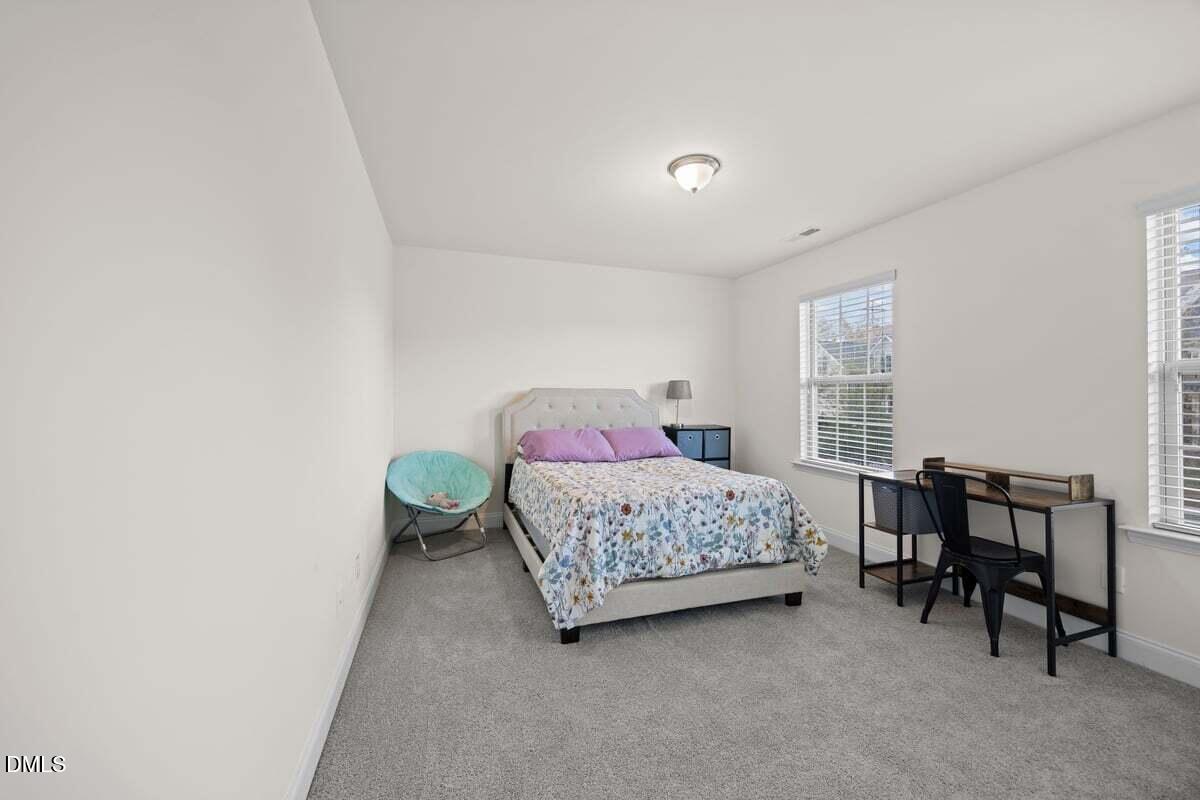 917 Stable Fern Drive Fuquay-Varina, NC 27526 - Photo 24 of 31 a bedroom with a bed and a table
