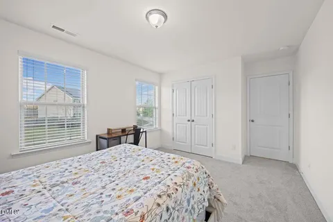 a bedroom with a large bed and a window