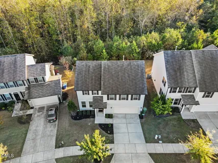 an aerial view of a house with outdoor seating