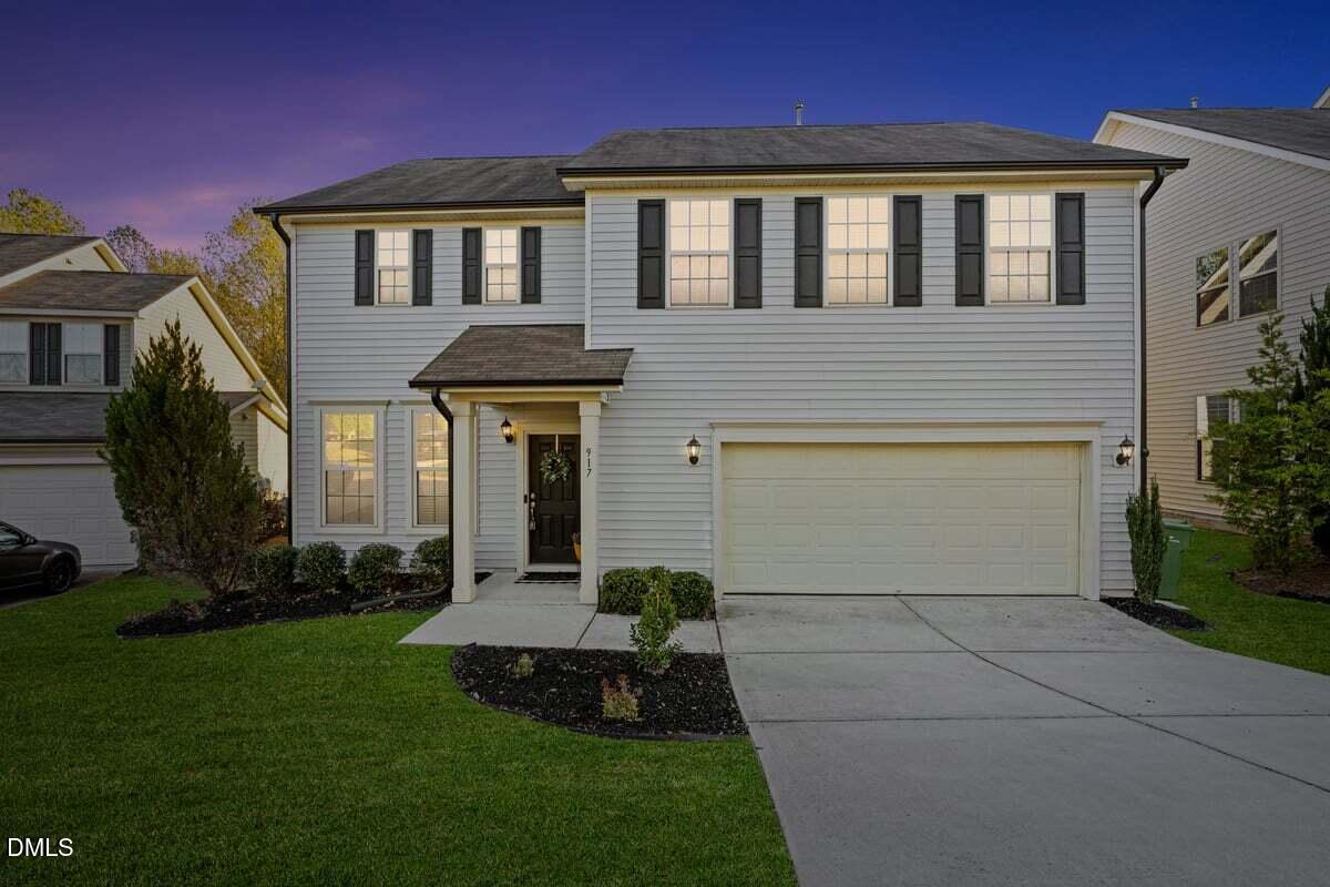 917 Stable Fern Drive Fuquay-Varina, NC 27526 - Photo 3 of 31 a front view of a house with a garden and plants