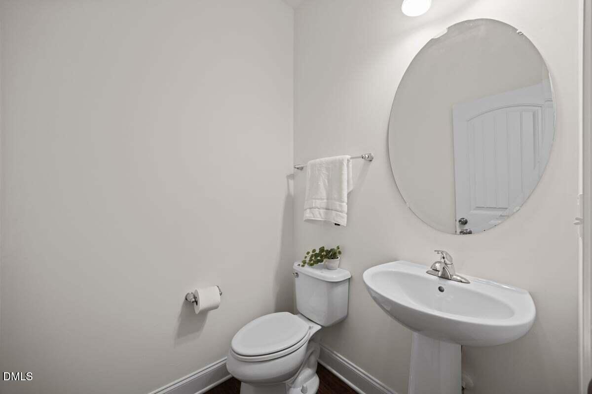 917 Stable Fern Drive Fuquay-Varina, NC 27526 - Photo 6 of 31 a bathroom with a sink a toilet and a mirror
