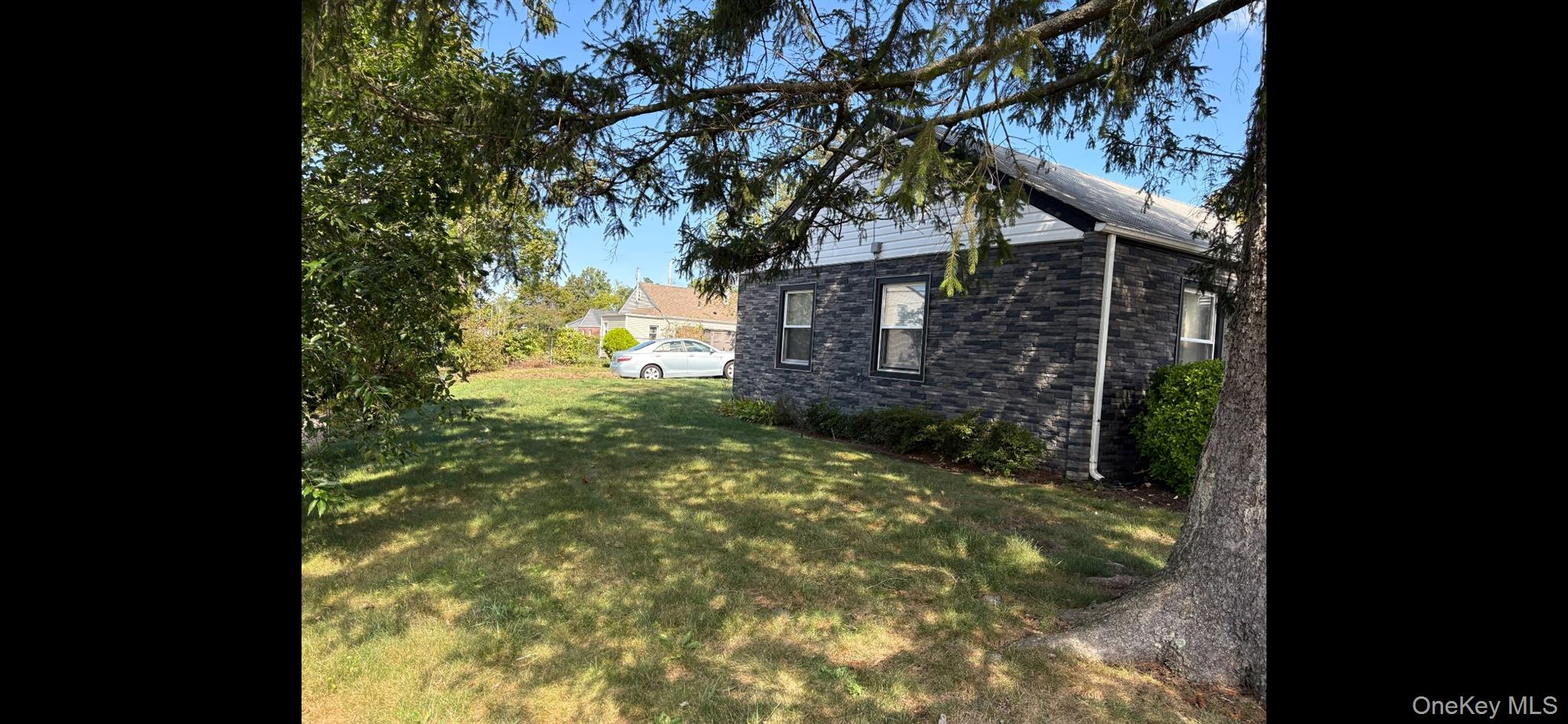 7 Pilot Street Hempstead, NY 11550 - Photo 2 of 3 a backyard of a house with lots of green space