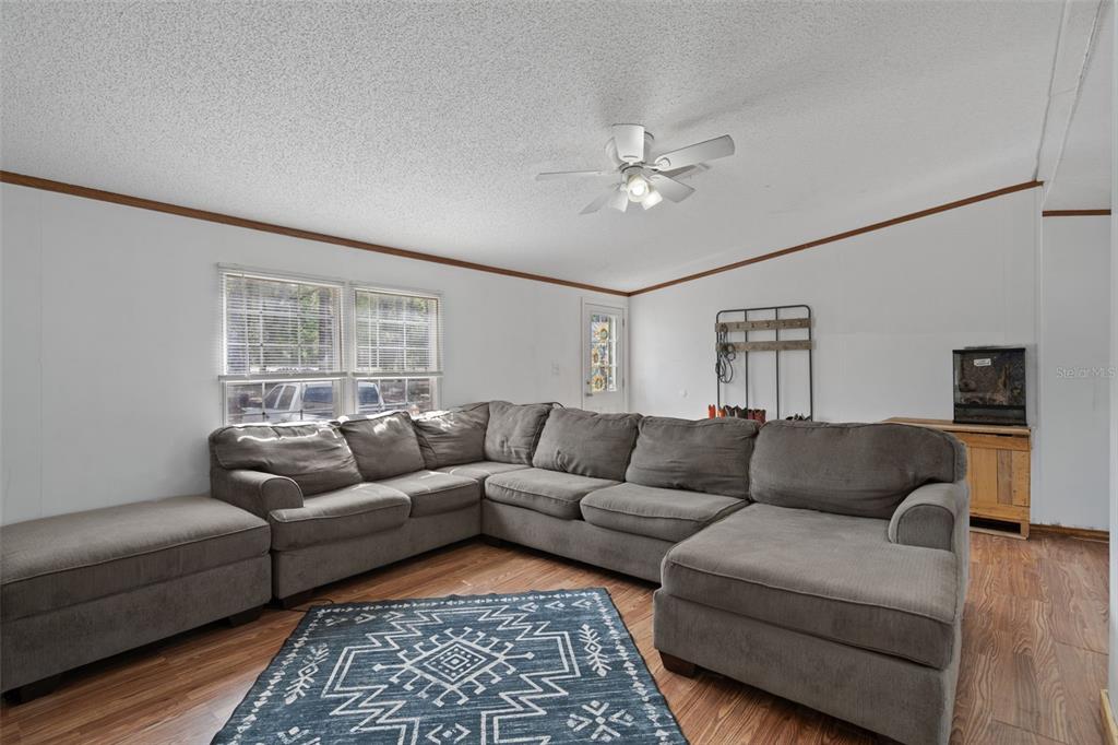 4059 McKethan Road Dade City, FL 33523 - Photo 19 of 50 a living room with furniture and a couch