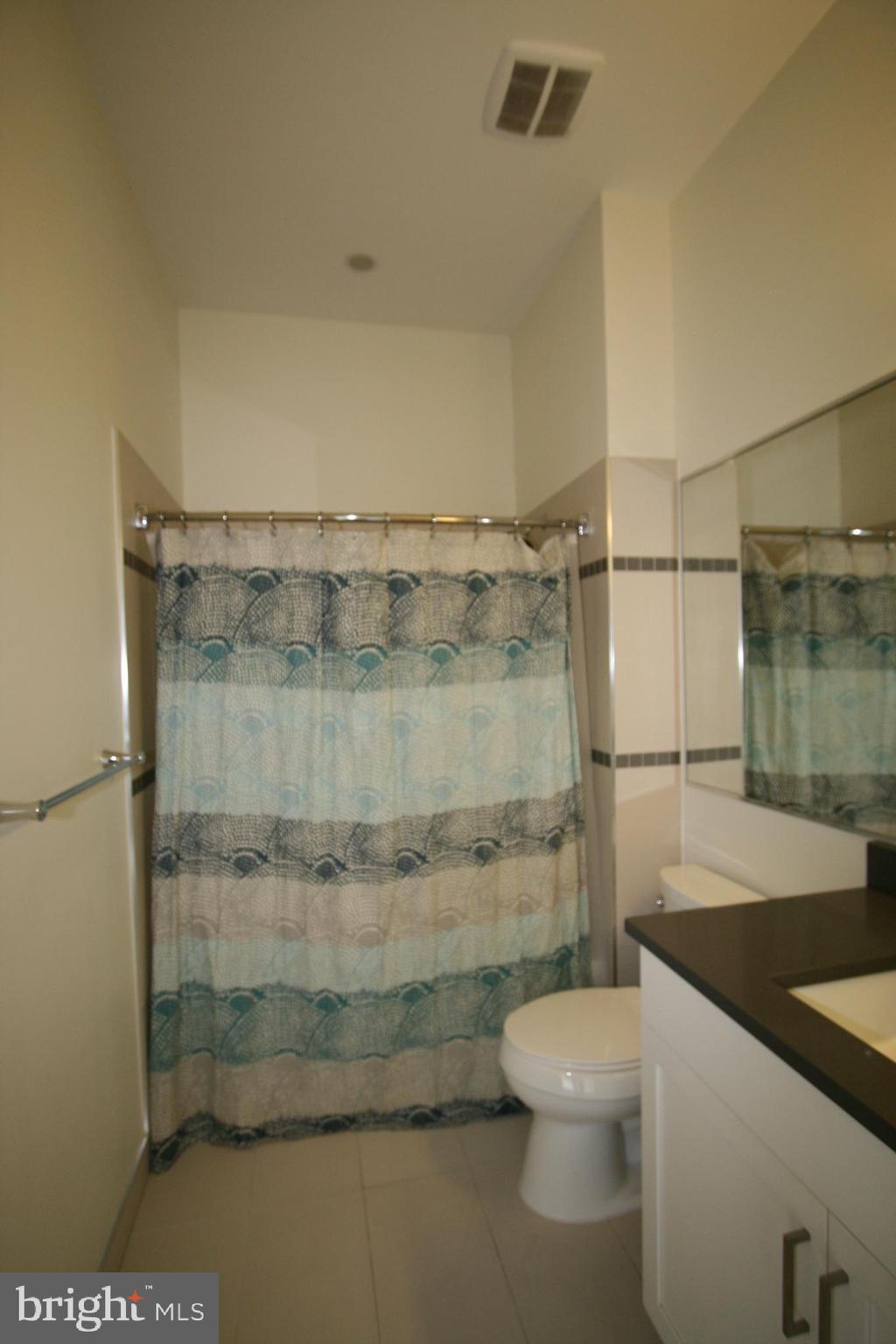 2550 17th Street Northwest, Unit 612 Washington, DC 20009 - Photo 51 of 55 a bathroom with a granite countertop shower a toilet and a sink