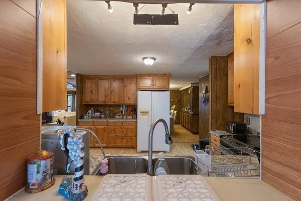 a kitchen with stainless steel appliances kitchen island granite countertop a sink and cabinets