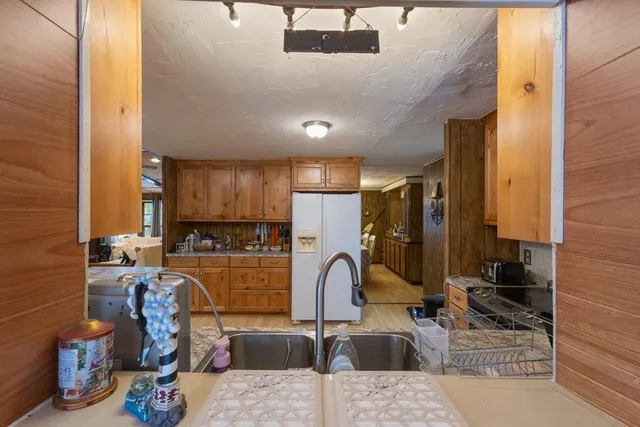 a kitchen with stainless steel appliances kitchen island granite countertop a sink and cabinets