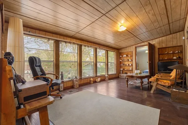 a view of a livingroom with workspace and windows