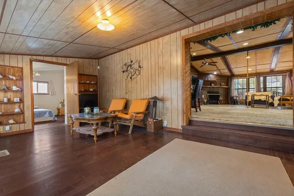 a view of a patio with table and chairs with wooden floor and fence