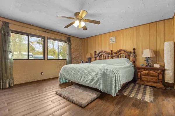 a spacious bedroom with a large bed and a large window