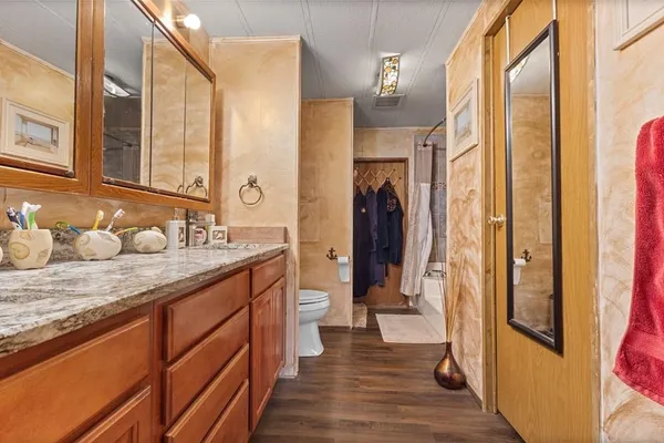 a bathroom with a granite countertop sink and a mirror