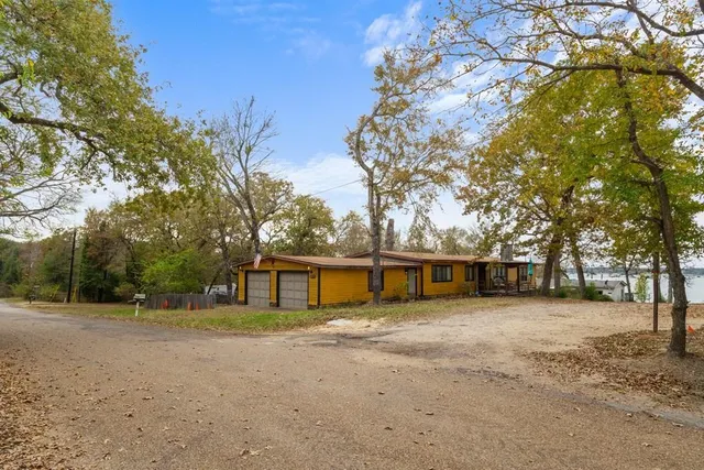 a view of a house with a yard covered in snow