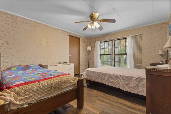 a bedroom with a bed and a chandelier