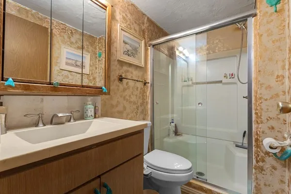 a bathroom with a sink toilet and shower