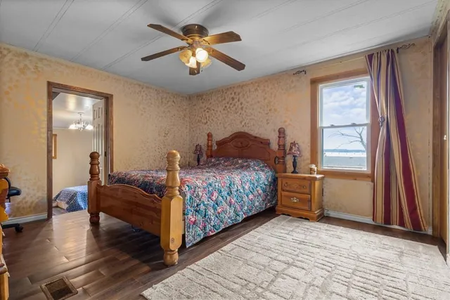 a bedroom with a bed and a chandelier